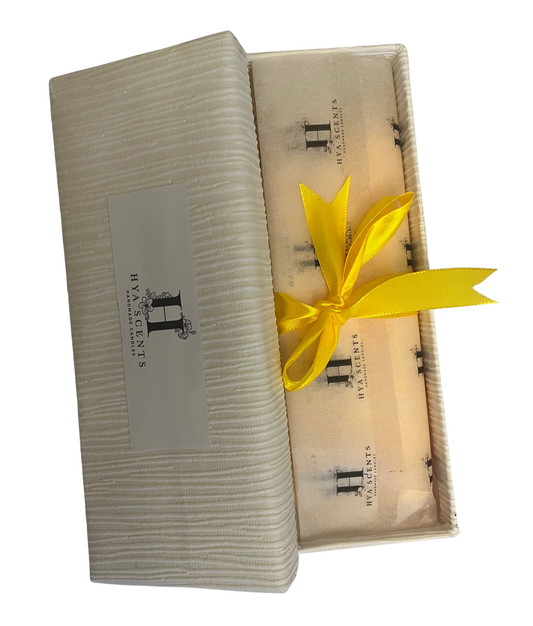 Gift box with a yellow ribbon and branded label on a white background